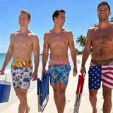 Three friends walking the beach in Cheeky Swim Trunks, front view